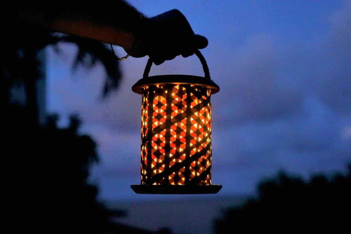 Hand holding the Shadow Lantern at dusk